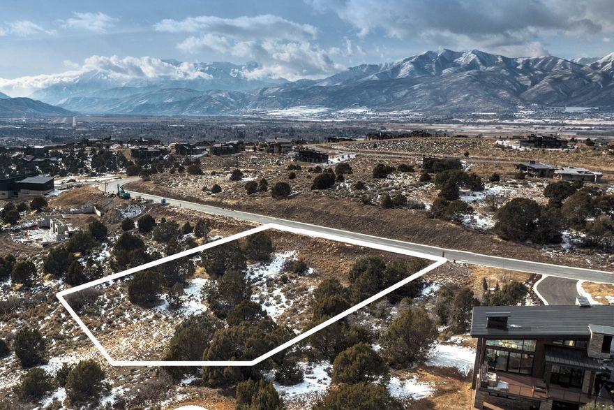 Homesite 592 in Red Ledges Mountainside Neighborhood offers a gentle downhill slope, perfectly positioned to capture sweeping views of the golf course and the Uinta Mountains, all while maintaining a sense of privacy among mature trees. This .80 acre lot is ideally located within walking distance to the future neighborhood pool and restaurant, presenting a compelling opportunity to get into one of Red Ledges' most exciting emerging areas. Bring your preferred builder and create a custom home design, or take advantage of thoughtfully designed floorplans available through Red Ledges Construction. Club membership is available with this property, offering access to two Jack Nicklaus Signature Golf Courses, tennis and pickleball, fitness and wellness center, equestrian facilities, two pools, and miles of trails, all supporting a year-round, four-season lifestyle.