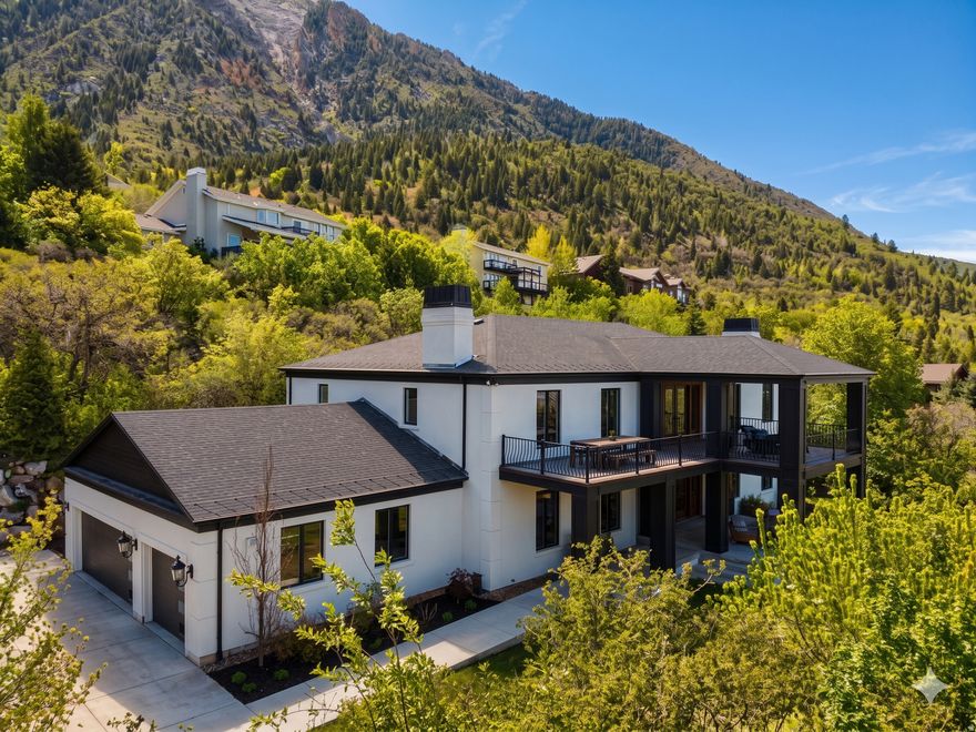Peerless Elegance Above the Clouds: An Olympus Cove Masterpiece. Perched atop one of the highest points of the prestigious Olympus Cove, this custom-designed estate offers a rare blend of architectural sophistication and rugged mountain seclusion. Situated on a private, wooded half-acre where wild turkeys roam and the city noise fades away, this 7-bedroom sanctuary is the pinnacle of modern luxury.  Forget the shovel -- the heated driveway ensures a seamless arrival to your 3-car garage (plus dedicated RV parking).  The Entryway: Step into a breathtaking foyer featuring classic checkered tiling and a striking custom-built staircase.  Work from Home: Perfectly positioned off the entryway, the private office offers a quiet, professional retreat away from the main living areas.  Artisanal Detail: The interior is anchored by a stunning German Schmear stone wall, adding an old-world, textured elegance to the modern architecture.  This estate is uniquely engineered for the ultimate in privacy and comfort, featuring three dedicated Master Suites.  The Main Level Master: Features a private en-suite bathroom, offering the ultimate convenience for guests or those seeking single-level living.  The Upper Master Retreat: A massive sanctuary boasting 100% gorgeous refinished hardwood floors and stunning views of the Salt Lake Valley.  Chef's Kitchen: Fully updated with a massive commercial-sized refrigerator, high-end finishes, and a dedicated butler's pantry.  Second Kitchen: A second full-sized kitchen downstairs makes this home an entertainer's dream or a perfect setup for long-term guests.  Atmosphere: Warm up by any of the 6 unique fireplaces scattered throughout the home's expansive living spaces, including 3 textured in imported Venetian plaster.   The Extras: A dedicated theater room, a private gym, and a year-round swim spa provide a resort-like experience without leaving home.  Outdoor Living: Take in the most iconic sunsets in Utah from the large balcony deck or the secluded, wooded lot.  Modern Systems: Effortless living with a tankless water heater, a bonus room (potential 8th bedroom), and 3 separate laundry hookups.  This is a rare opportunity to own a legacy property at the top of the Cove.    Square footage figures are provided as a courtesy estimate only and were obtained from previous listing.  Buyer is advised to obtain an independent measurement.