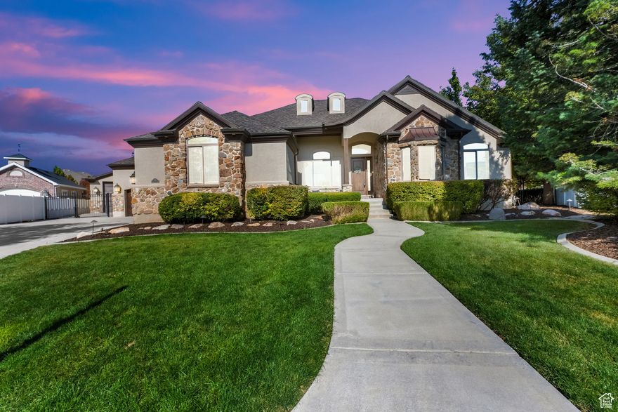 Award-Winning Luxury Executive Home  Voted Best of Show and People's Choice in the 1999 Salt Lake Parade of Homes, this stunning residence is a true standout.  From the moment you enter, soaring windows, vaulted ceilings, walnut hardwood, and travertine floors set the tone. The main level offers an elegant executive study, grand owner's suite with spa-like bath, double vanity and walk in closet and guest suite.  Gourmet kitchen with granite countertops, gas cooktop, stainless steel appliances, and walk-in pantry. Main floor laundry and mud room with lockers. The great room with vaulted ceilings is anchored by a natural stone fireplace which flows effortlessly to outdoor living.  The entertainer's dream continues in the fully finished basement with theater-ready great room, second kitchen, three very spacious bedrooms with walk in closets, full bath, and second laundry. Large storage room with built in shelves. Pool table included. 2 furnaces & water heaters.  Car lovers and hobbyists will appreciate two oversized attached two-car garages, plus a heated detached garage with suspended floor and private exercise/dance studio below. 608 sq ft included in basement sq ft. Beautifully landscaped cul-de-sac lot is a private oasis with mature trees, 20' x 50' gunite salt water pool with slide, spa & Shamu shelf, stamped concrete patio, and a pool house with 1/2 bath. Lighted sport court. New lifetime roof.  Located near the Jordan River Trail that spans from Utah County to Davis County with playgrounds and fishing pond!  This home is an absolute delight!