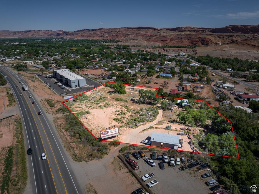 PRIME DEVELOPMENT OPPORTUNITY! Unlock the exceptional potential of this 4.86-acre property, with potential of all Highway Commercial zoning, with 260 feet of Highway 191 frontage across from the Utah State University campus.  Perfectly positioned for maximum visibility and accessibility with dual access from Highway 191 and Arnel Lane. The site includes a 30' x 50' shop featuring two spacious bays, 3-phase power, and a half bath, perfect for various operational needs or storage requirements.  The excellent tiered lay of the land lends itself well to a tiered mixed-use development with the multiple flat areas that will also allow for expansion or additional structures, with room for parking, storage, or future commercial builds- including high density housing. Located just minutes from Moab's city center, this property offers high traffic exposure and excellent accessibility with water and sewer on the site.  This property is not just a piece of land; it's a canvas for your business and development aspirations. Whether you're looking to establish a new headquarters, expand your operations, build housing or invest in a lucrative commercial opportunity, this site provides the foundation you need.