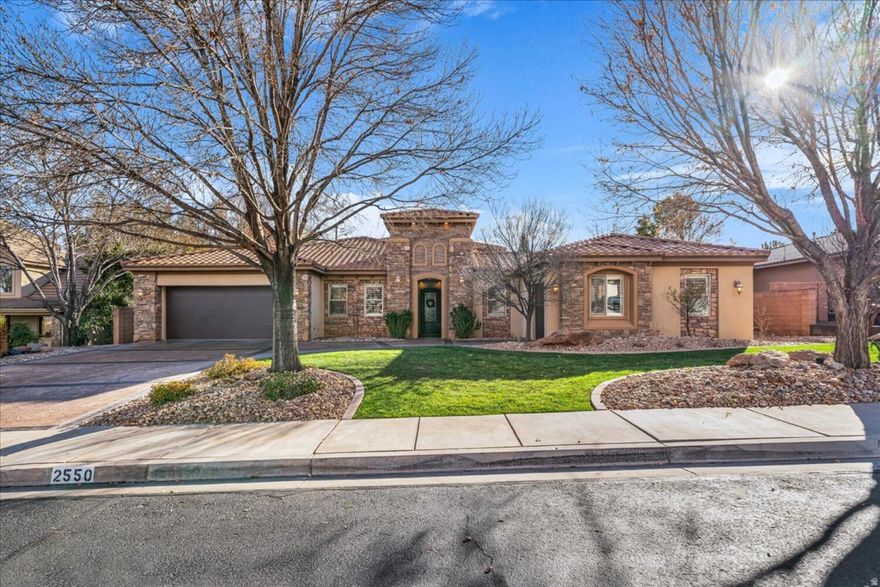 Experience the romance and privacy of a true Italian villa situated on a rare half-acre lot in Little Valley. With over 6,000 square feet of living space just moments from top-rated Crimson Cliffs schools, this property offers a combination of land, size, and location that is incredibly difficult to find.  The home is set around a large interior courtyard that creates a seamless indoor-outdoor living experience. Inside, formal living and dining rooms provide versatile spaces for entertaining. Vaulted ceilings open up the kitchen and casual dining area which flow naturally into the family room, along with a butler's pantry and a nearby nook for a home office. The primary suite offers a quiet retreat with direct access to the patio and an en-suite bath featuring a soaking tub and walkthrough shower.  The backyard captures the feel of a private resort with mature shade trees and lush grassy lawns. You can swim in the pool and spa with waterfalls and a grotto or host friends at the built-in BBQ and fire pit areas. This property brings a distinct Mediterranean lifestyle to one of the most desirable neighborhoods in St. George.