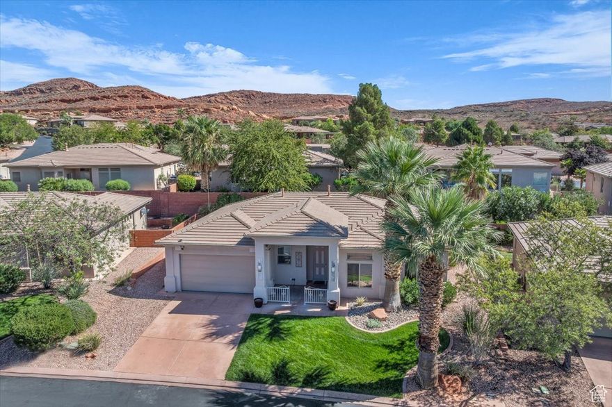 Charming home located in the sought after Paradise Canyon community, nestled at the base of the Red Cliffs Reserve that offers breathtaking Red Mountain views and easy access to scenic hiking/biking trails. This well cared for property features new flooring in primary bedroom, high ceilings, custom tile arch in living room along with recent updates such as new water heater, AC and furnace. Functional floor plan with a versatile office/den. Step outside to a covered patio with a tranquil water feature and low maintenance landscaping, creating the perfect setting for relaxing or entertaining. Oversized 2 car garage with extra storage cabinets. HOA amenities include access to 1 indoor pool, 2 outdoor pools, clubhouse with event center library and gym.