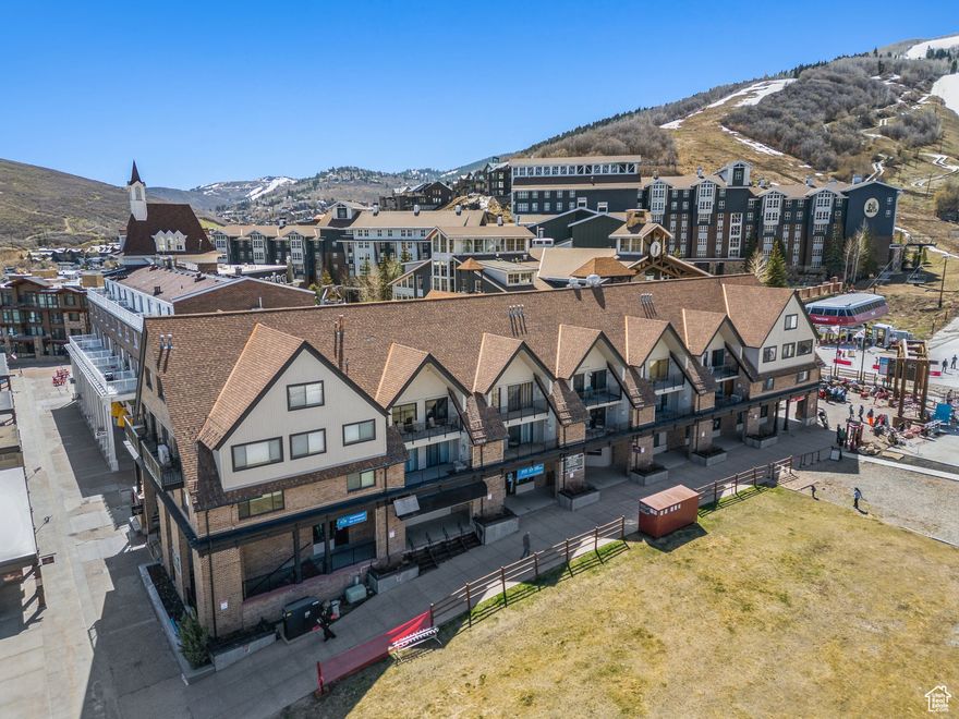 Experience ski-in/out access and effortless mountain living in this ski condo at the base of Park City Mountain Resort. Located just steps from the Pay Day lift, village restaurants, cafes, shops, and entertainment, this well appointed ski retreat offers the perfect balance of luxury and convenience with breathtaking mountain views.  Upon entering the condo, you're greeted by a warm and inviting layout with updated plank flooring and mountain slate running throughout the residence. Two sets of large balcony double doors bring in an abundance of natural light.  The full-sized, upscale kitchen is equipped with granite countertops, stainless steel appliances, custom cabinetry and a beautiful stone kitchen backsplash. Snack and dine at the countertop bar that seats four.  Detailed wainscoting adorn the walls. The spacious living area features a cozy fireplace and relaxing apres ski area perfect after a long day on the slopes. Soak in the sun and entertain guests on the oversized balcony with sweeping unobstructed front-row views of the Park City ski runs.  The open and expansive bedroom is your own personal sanctuary with a large bathroom and access to the condo's private balcony. The second full bathroom is located near the foyer and includes a large double-sink vanity with ample cabinet and drawer storage space. A rare dedicated underground parking space is included with the condo.  Location is everything and you can't get any closer than this. Park City's Main Street Historic District is just a short 5-minute drive or 7-minute bus ride away. Unlimited access to world-class ski resorts, hiking trails, local markets, and other unique festivities are right out your door. Do not miss the opportunity to own in the heart of Park City Mountain Resort and live a year round resort lifestyle.    Square footage figures are provided as a courtesy estimate only and were obtained from county records .  Buyer is advised to obtain an independent measurement and verify all.