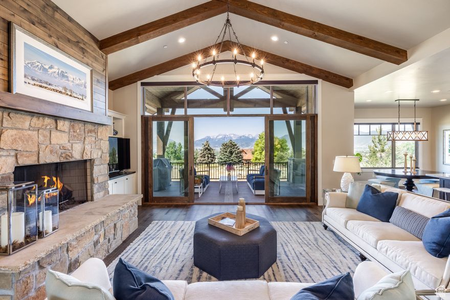 Red Ledges is a private four season recreational community tucked into the Heber Valley and is one of Utah's most sought after areas with its panoramic vistas of Timpanogos and superb amenities.  The community includes an 18 hole Jack Nicklaus Signature Golf course, clubhouse with dining at the Juniper Grill, golf school, tennis academy, pickleball courts, equestrian  center, swim and fitness facilities, Hiking and biking trails and a ski shuttle service. 1225 Oquirrh Mountain Drive is a prime location in the southwest corner of Red Ledges.  It is a popular location because of the serenity, privacy and sweeping views that come with the larger lots and distance from the main community thoroughfares. A beautiful four bedroom home that welcomes you to style, comfort and a timeless interior design blending functionality with superb construction and refined finishes.  The inviting open living area features vaulted ceilings, stone fireplace, built in cabinetry. The practical and well designed gourmet kitchen has Thermador appliances, attractive cabinets, pantry, a large island perfect for entertaining and a breakfast nook. While the expansive window wall floods the living area with light, the highlight is the spectacular Mt. Timpanogos views. A bonus is its easy access to the private covered deck where one can unwind and enjoy the ever changing mountain scenery. The lower level has a spacious family room that opens onto the covered patio with hot tub. There are three additional bedrooms, baths and extra storage. Enjoy the location and floor plan by viewing the drone video and 3D tour. This home has a Red Ledges Lifestyle membership.