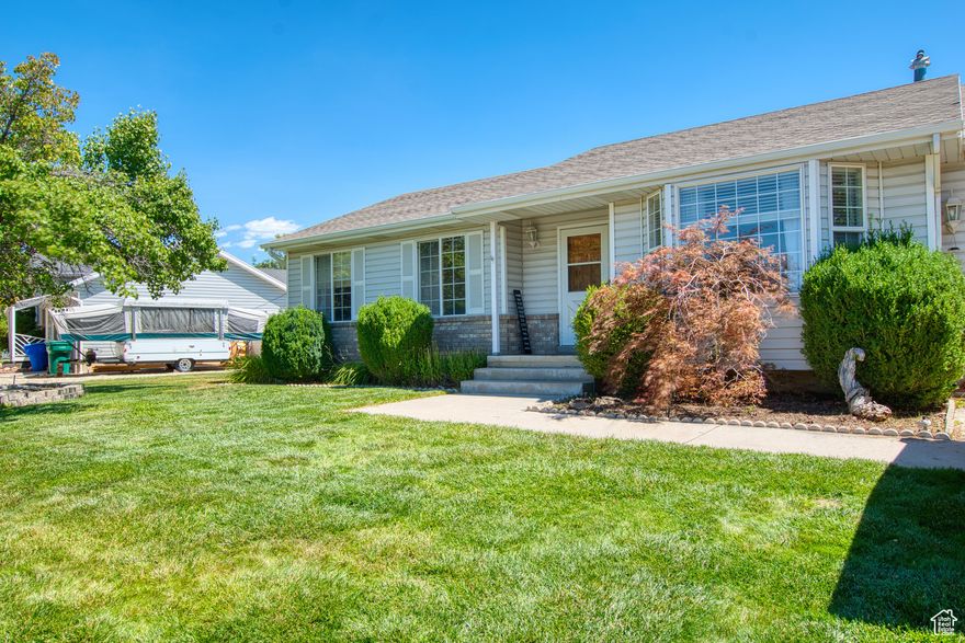 MOTIVATED SELLER IN THE HEART OF LEHI WITH $3000 CARPET ALLOWANCE TO SELECT YOUR IDEAL CARPET COLOR AND STYLE!  Seller offering 1/0 rate buydown with preferred lender - 5.241% first-year rate available. Contact agent for details. GORGEOUS NEW kitchen with many conveniences and tons of cupboard space! Fully fenced expansive backyard great for family gatherings and/or pets. This home is located in a quiet neighborhood and within walking distance to a HUGE, FUN, NEW PARK & soccer fields. It offers comfort, convenience, and room to grow. BEAUTIFUL Bamboo flooring and laundry on main level.  The spacious main level master suite includes a separate tub and shower for a luxurious touch.  Enjoy easy access with sliding glass doors leading to a fully landscaped yard with stunning mountain views. In the basement are TWO bedrooms and family room with PLENTY of storage space, perfect for expanding your living area. Basement is plumbed for another bathroom, plus a NEW sink and toilet to go with it that the new owner can install.