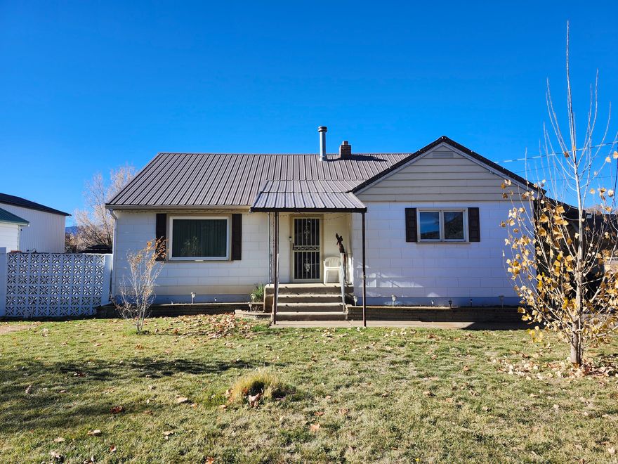 Motivatd Seller! Located in the heart of Morgan, this 4 bed/2 bath home offers close proximity to schools, shopping, and parks. New upstairs carpet . Kitchen with abundant cabinet space, wood-burning stove, and plenty of storage. Outbuilding with loft storage. Newer double-pane windows and newer furnace. Enjoy the covered patio on summer evenings. Additional parcel #00-0003-8909 included. Sq ft per county records; buyer to verify.