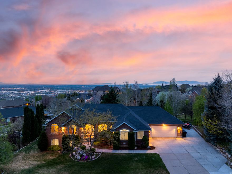 Beautifully remodeled, this all-brick rambler with a walkout basement offers an exceptional blend of luxury, flexibility, and everyday comfort. Framed by sweeping views of Ben Lomond and the valley below, the home is set up for elevated living on every level.  Inside, spacious interiors are tailored for both entertaining and relaxed daily life, with two full kitchens, two laundry rooms, and generous family rooms on each level that create ideal separation for hosting guests, multigenerational living, or extended stays. With 5 bedrooms plus an office, the layout offers room to grow, gather, and retreat in comfort. Modern farmhouse finishes bring style throughout, blending clean lines, inviting textures, and timeless design. Gas fireplaces on both levels add warmth and ambiance.  The garage setup is equally impressive, featuring a large 2-car garage designed to accommodate a full-size long bed double cab truck, along with an additional 3rd-car garage for extra vehicles, storage, or recreational gear. A substantial RV pad beside the garage is ready for today's larger motorhomes and toy haulers, making this property especially appealing for those who value adventure as much as home. Outside, the fully landscaped yard creates a polished setting to enjoy the natural beauty that surrounds you. Whether you are taking in the mountain backdrop, enjoying nearby trail access, or heading out for skiing, hiking, biking, and year-round Northern Utah recreation, this home is perfectly positioned for an active lifestyle. With its rare combination of space, versatility, storage, and scenic appeal, this is a property that lives as beautifully as it looks. Buyer to verify all.