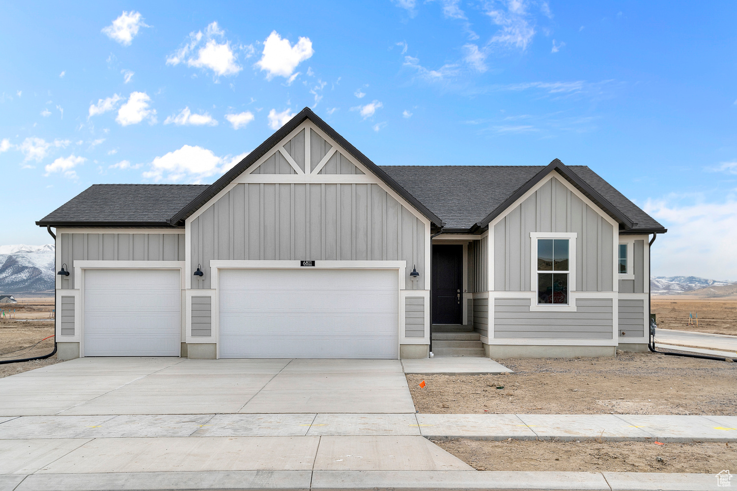 This beautiful 1350 Farmhouse combines modern efficiency with farmhouse charm! The stylish kitchen features gray laminate cabinets, quartz countertops, and stainless steel gas appliances, making it a functional and stylish center for the home. With laminate hardwood, vinyl tile, and carpet flooring, this home is designed for comfort and durability. The spacious 3-car garage with a keypad and exit door adds convenience, while the box windows in the kitchen nook and owner's bedroom enhance natural light and charm. The walk-up basement door offers added accessibility and functionality, while practical features include can lighting, Christmas light outlets, a 40-gallon water heater, energy-efficient options, craftsman base & casing and 2 tone paint. The cultured marble shower surrounds in the owner's bathroom and satin and brushed nickel hardware add a touch of elegance. This home offers a cozy, efficient, and stylish space to call home.