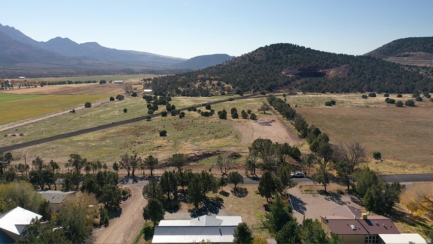 Escape the crowds and enjoy cool Central nights on this flat, usable .22-acre lot with trees. With land getting so expensive, this is a perfect corner lot with endless options and priced perfectly. Only about 27 miles to St. George, 15 miles to Enterprise and 8 miles to Pine Valley, you're close to services yet far from the hustle. Play all day at nearby Pine Valley, Enterprise, Baker and Gunlock reservoirs, then come home to quiet, wildlife and star-filled skies. There are no improvements to the lot but everything is close to connect and be ready to go!