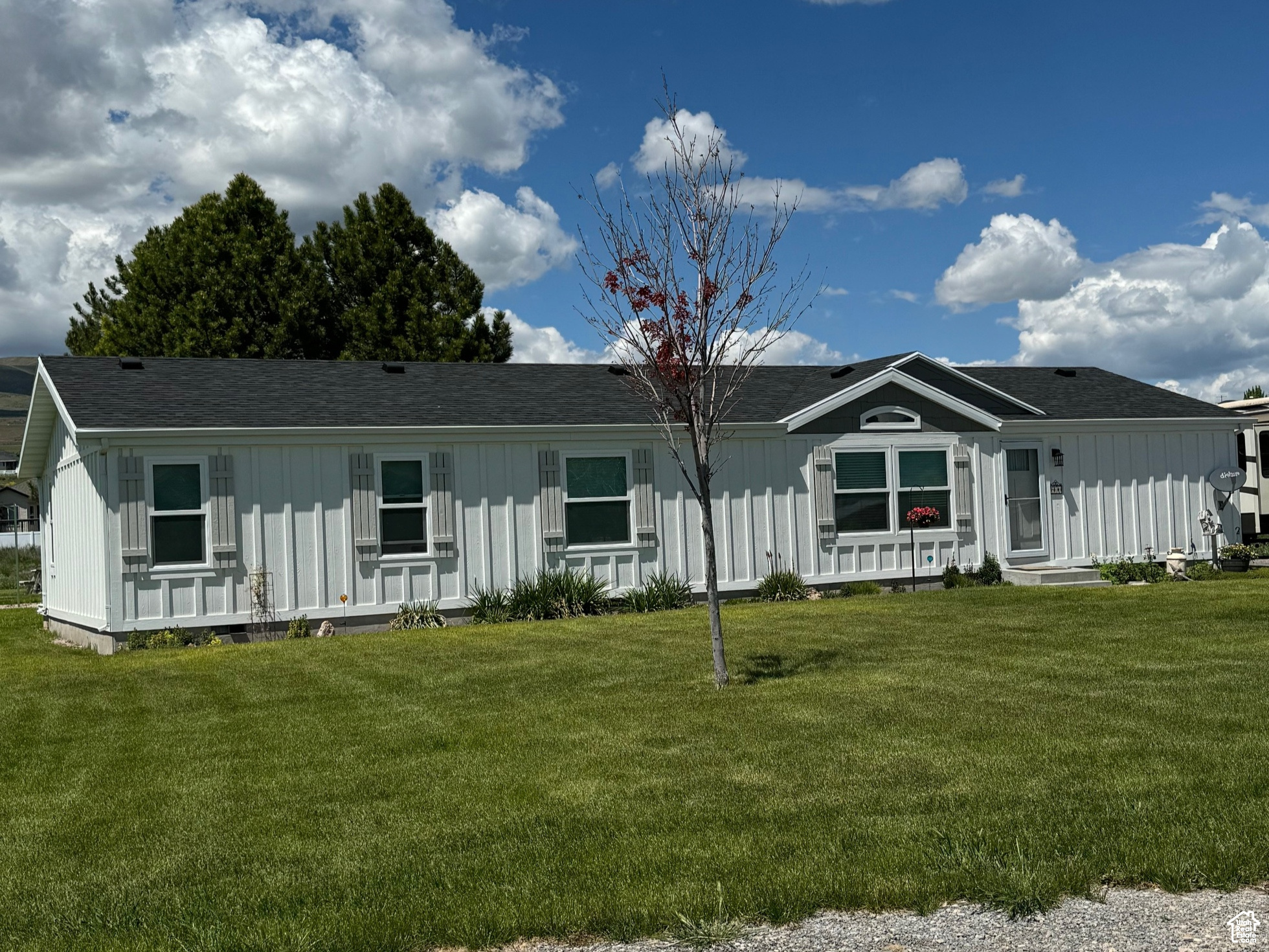Nestled on the foothills of Tremonton, this 2+ acre oasis offers a rare gem in the community with its expansive lot size. A haven of privacy and seclusion, this single-level home boasts new siding, windows, and roof upgrades. The open floor plan caters to modern living, creating a perfect harmony of space and comfort. Situated in a new development off 2300 West, views enhance the serene setting. Don't miss the opportunity to experience this tranquil retreat. Asphalt road paving and curb and gutter are in the process of being installed at no expense to the property owner. Zonng allows for livestock! Contact us to schedule a viewing today!