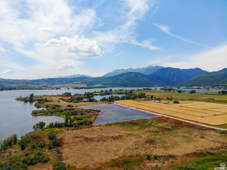 Situated on the shores of Pineview Reservoir, this extremely rare, 5-acre lakeside property boasts unparalleled views with plenty of space to build your dream home. Located in the Eden Lake Meadows gated community with private access to the water, this lot overlooks Pineview Reservoir with direct, unobstructed views of Snowbasin Resort, Ben Lomond and Willard Peaks, and the surrounding mountains. The property is also centrally located and is minutes from Wolf Creek golf course, Powder Mountain, and dozens of hiking and biking trails. With direct access to the water, there is no better spot for fishing, kayaking, paddle boarding and more. Don't miss out on this opportunity to be on the lake!