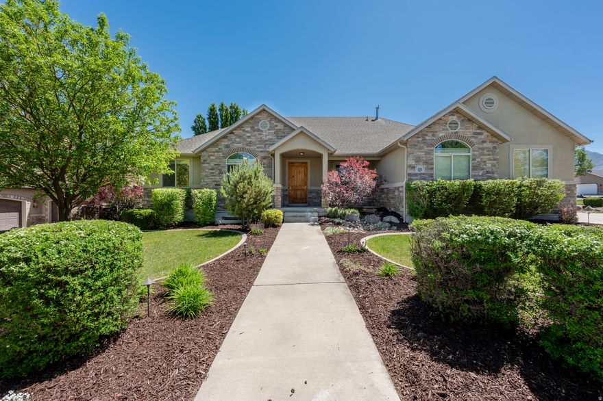 Beautiful rambler in Spanish Fork's desirable River Cove area. Property features 5 bedrooms, 3 full bathrooms, 1 half bath, approximately 4,093 finished square feet, a fully finished basement, spacious great room, den/office, large kitchen, owner's suite, a one of a kind children's playroom, and excellent storage. Professionally landscaped yard with bubbling water feature, covered patio, fully fenced backyard, 3-car garage, and RV parking. Convenient location near walking trails, parks, and schools. Buyer and buyer's agent to verify all information, including square footage, acreage, schools, zoning, and property details. This home is vacant; all photos that include furniture are virtually staged.