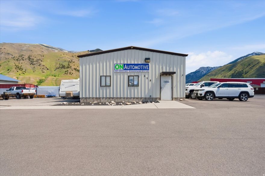 Located at 215 Hammer Rd in Hyrum, this 1-acre commercial property offers a practical setup for a variety of uses. Built in 1994, the 2,400 sq ft building is laid out with functionality in mind, featuring two private offices, a reception area, and 2 bathrooms. The shop area is equipped for hands-on work, including space for vehicle service and/or warehousing space. The lot provides room for parking, storage, or  future expansion based on your needs. A straightforward property with the space and layout to support day-to-day operations.