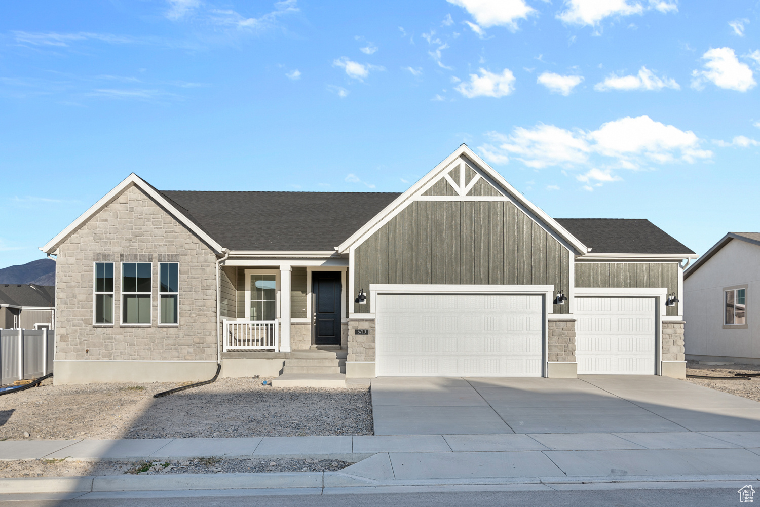 Brand new, charming 1550 farmhouse home in a wonderful Stansbury community near parks, schools, lake and more! This delightful residence features a modern kitchen with gray laminate cabinets, elegant quartz kitchen countertops, and stainless steel gas appliances. The flooring provides a blend of laminate hardwood, tile, and carpet, adding warmth and sophistication to this home! Also included you will find a spacious 3-car garage with a keypad and exit door, a box bay window in both the kitchen nook and owner's bedroom, and convenient Christmas light outlets. Enjoy the brushed nickel hardware, a 40-gallon water heater, and energy-efficient options for easy maintenance living. The wood railing at the stairway enhances the farmhouse appeal, while the owner's bathroom boasts cultured marble shower surrounds that provide a perfect blend of modern amenities and classic farmhouse style in this beautiful home!