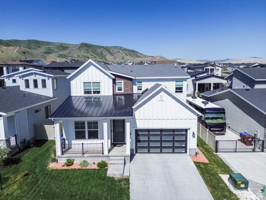 SELLER FINANCE AVAILABLE  Don't miss this stunning home in Juniper Bend, a private gated community known for its breathtaking views and resort-style amenities. This spacious 4-bedroom, 3.5-bath residence features high-end upgrades throughout, including granite and quartz countertops in the kitchen, 11' ceilings, elegant 8' doors, and a thoughtfully designed floor plan. Enjoy seamless indoor-outdoor living with a covered patio that takes full advantage of the picturesque surroundings.  The main level includes a convenient bedroom with an en-suite full bath-ideal for guests or main-level living.  Juniper Bend offers exceptional amenities such as a clubhouse, pool, spa, and fitness center, and is just minutes from shopping, dining, scenic hiking and biking trails, and Blackridge Reservoir.  A prime location paired with a beautifully upgraded home-don't miss this opportunity!  All information is provided as a courtesy and should be independently verified by the buyer.