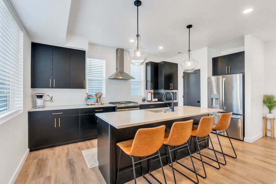 Showcasing striking MODERN exterior architecture, these thoughtfully designed townhomes are filled with light and style. Expansive windows flood the home with NATURAL LIGHT, enhancing the OPEN-CONCEPT layout and sleek, contemporary finishes throughout. The kitchen features modern FLAT-PANEL CABINETRY, QUARTZ countertops, STAINLESS STEEL appliances, statement PENDANT LIGHTING, and bold black hardware-creating a space that's both functional and visually stunning.  Each home offers THREE GENEROUS BEDROOMS and 3.5 baths, including a SPA-INSPIRED primary suite with a full EURO-GLASS shower. Designer TWO-TONE interior paint, paired with contrast painted interior doors, adds a refined, custom feel rarely found at this price point. LUXURY HARD SURFACE FLOORING runs throughout the main living areas, and this home includes a spacious two-car garage. Located in theHIVE, a community-within-a-community, residents enjoy beautifully landscaped GREEN SPACES and private PICKLEBALL courts-all with a very LOW HOA. Just minutes from Station Park in Farmington and downtown Salt Lake City, this is ideal for commuters and lovers of modern design alike.