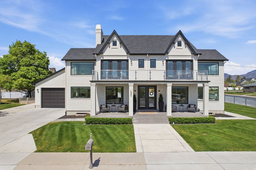 This fully custom home offers the perfect blend of luxury, space, and lifestyle. Thoughtfully designed with 5 bedrooms and 4.5 bathrooms, the layout features a stunning great room that serves as the heart of the home-ideal for both everyday living and entertaining-along with a dedicated theater room for the ultimate movie nights with family and friends. Large windows throughout capture natural light and showcase the surrounding views, while three full HVAC systems with four separate zones provide efficient, customized climate control year-round. One of the standout features is the expansive 1,500 sq ft garage/shop, complete with a car lift and full kitchen in a 50's diner style-perfect for hobbyists, collectors, or those needing versatile workspace. The property also features generous RV parking that can easily accommodate an RV, camping trailer, boat, or even a semi, with space to spare. Step outside to a beautifully maintained lawn and more views of the mountains. Upstairs, the balcony and bedroom views are truly breathtaking, providing a daily backdrop of Utah's natural beauty-an incredible opportunity to own a home that seamlessly combines comfort, functionality, and elevated living. Square footage figures are provided as a courtesy estimate only and were obtained from appraisal; buyer is advised to obtain an independent measurement.