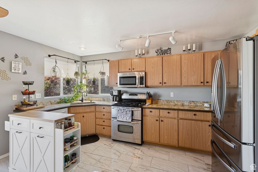 Stop scrolling and start living! This fantastic 2,264 sq. ft. home in the heart of Tooele is the perfect launchpad for your homeownership journey. With five bedrooms and three full bathrooms, you'll have all the room you need for family, hobbies, and guests. Unleash your inner chef in the large, inviting kitchen, now featuring a gas range and double oven-making holiday feasts and weeknight dinners a breeze! The fun continues downstairs in the huge basement family room, your future go-to spot for epic movie marathons or game nights. The .18-acre lot includes a 2-car garage and a massive shed for extra storage. This incredible home is your ticket to creating lasting memories. Don't let this one get away! Call to schedule your private tour today and picture your future here.  Square footage figures are provided as a courtesy estimate only and were obtained from County Records.  Buyer is advised to obtain an independent measurement and verify all information.