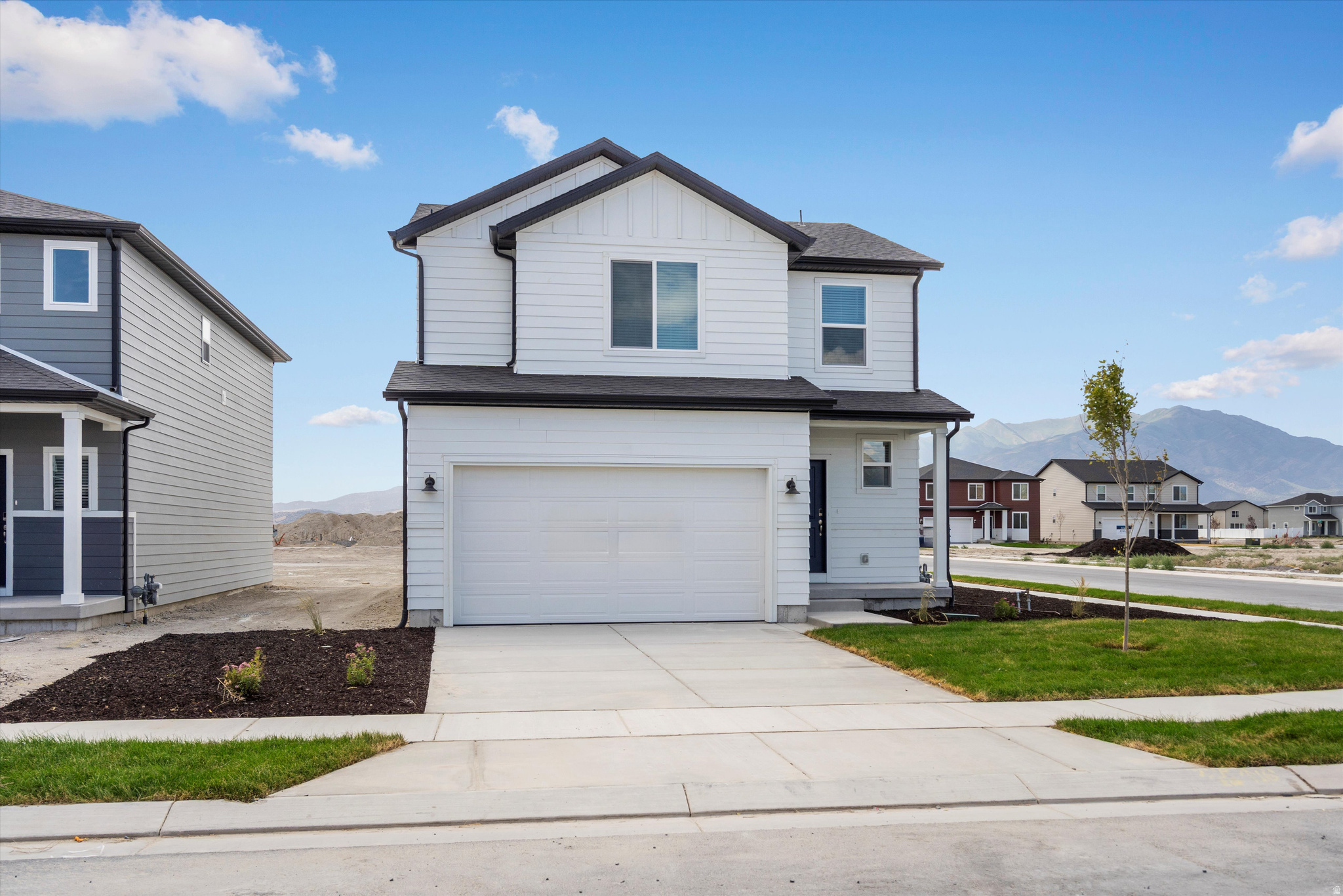 **DISCLAIMER** Exterior color and elevation may vary. Contemporary two-story residence featuring white siding and black trim accents