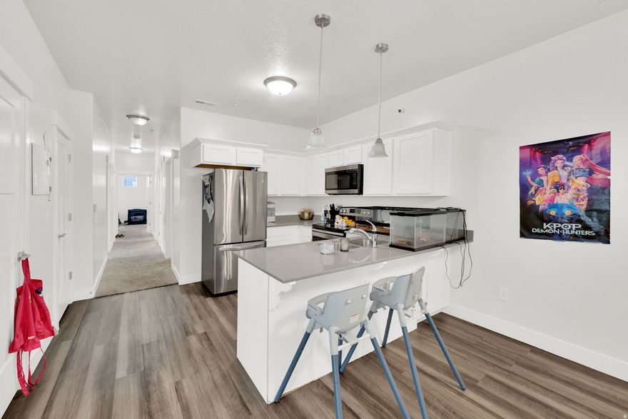 Step into this sleek, main-floor condo located in one of Utah's fastest-growing communities. Built just a few years ago, this home offers the perfect blend of modern finishes and effortless accessibility. Forget hauling groceries up stairs-the attached garage leads you right into a bright, open floor plan.  Location is everything here. You are situated directly adjacent to the clubhouse and pool, making it feel like you have a private resort right outside your front door. Whether you're looking for a primary residence or a solid addition to your portfolio, this unit delivers.  Please Note: This is a short sale. All offers are subject to lender approval. Our team is committed to a quick, transparent, and efficient short-sale process to get you to the closing table.