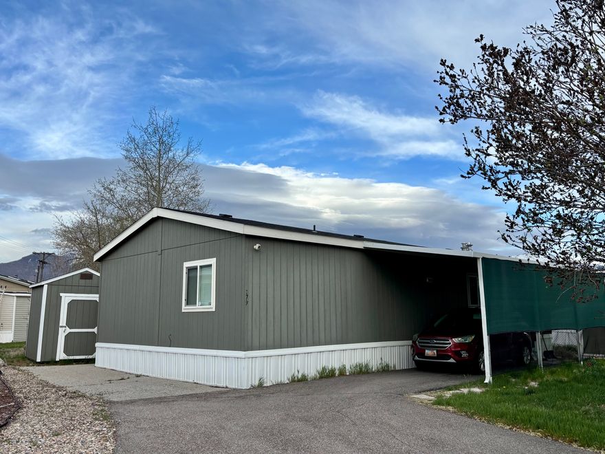 **BACK ON MARKET** Great location and great price! This double wide feels spacious with 3 bedrooms, 2 full bathrooms and a large open living/kitchen area. The home comes with 2 sheds, a covered back deck and a fully fenced yard - one of the largest in the community, great for kids and/or pets. Extra long driveway that can accommodate multiple cars if needed on the secondary driveway as well. Located right by HAFB, restaurants, shopping, schools. Quick access to Highway 89 or I-15. This community has a pool, basketball court, playground, clubhouse and bbq area. There is a lot of space to take walks with family or pets. Safe and friendly neighborhood. Square footage figures are provided as a courtesy estimate only and were obtained from Rolling Hills records. Buyer is advised to obtain an independent measurement.