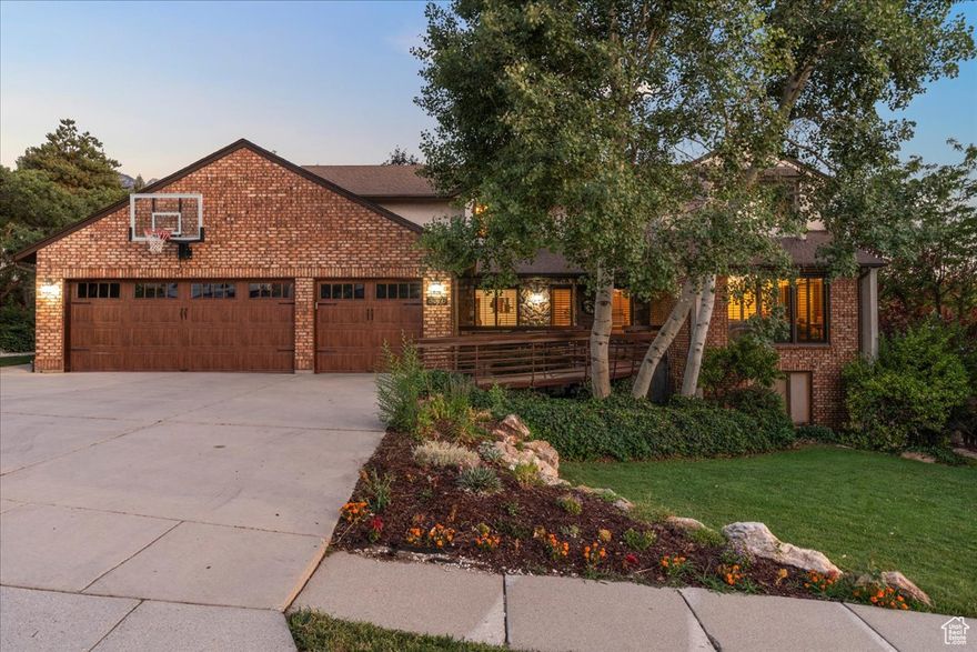 Tucked Away with Big Views & Big Adventure Just Minutes Away.  A rare find in Cottonwood Heights offering 8 bedrooms, 5 bathrooms, and expansive living spaces, all on a .38-acre lot with incredible mountain and valley views. Perfectly positioned just off Wasatch Blvd, you'll feel tucked away in a peaceful neighborhood while being just minutes from Little and Big Cottonwood Canyons. World-class skiing, hiking, and biking are practically in your backyard, while downtown Salt Lake City and the airport are less than 25 minutes away.  Inside, the home's vaulted ceilings and walls of windows flood the spaces with light and frame those breathtaking views. The soaring family room features a dramatic floor-to-ceiling rock fireplace, a true showstopper and the heart of the home. The open kitchen is designed for entertaining, with seamless flow into the dining and living areas.  Outdoor living is just as impressive. From the spacious Trex deck to the beautifully landscaped backyard complete with a waterfall and stream, this is the kind of space that invites both lively gatherings and quiet moments of mountain serenity. There's even an in-ground trampoline for a little extra fun.  The home's versatile layout includes a full mother-in-law apartment with its own private entrance and parking for two or use this area for your RV. This incredible suite offers three bedrooms, two bathrooms, a full kitchen, and two living areas, perfect for extended family, guests, or rental potential. The walkout basement also provides options for multi-generational living or flexible space to fit your needs. Step out the french doors and take a soak in the included hot tub!  Additional features include an extra-deep 3-car garage for all your gear and toys, meticulously maintained interiors, and generously sized rooms throughout.  Whether you're chasing first tracks on a powder day, enjoying a summer evening on the deck, or gathering with friends around the fireplace, this home offers the perfect blend of adventure, comfort, and space.  Square footage figures are provided as a courtesy estimate only and were obtained from tax records.  Buyer is advised to obtain an independent measurement.