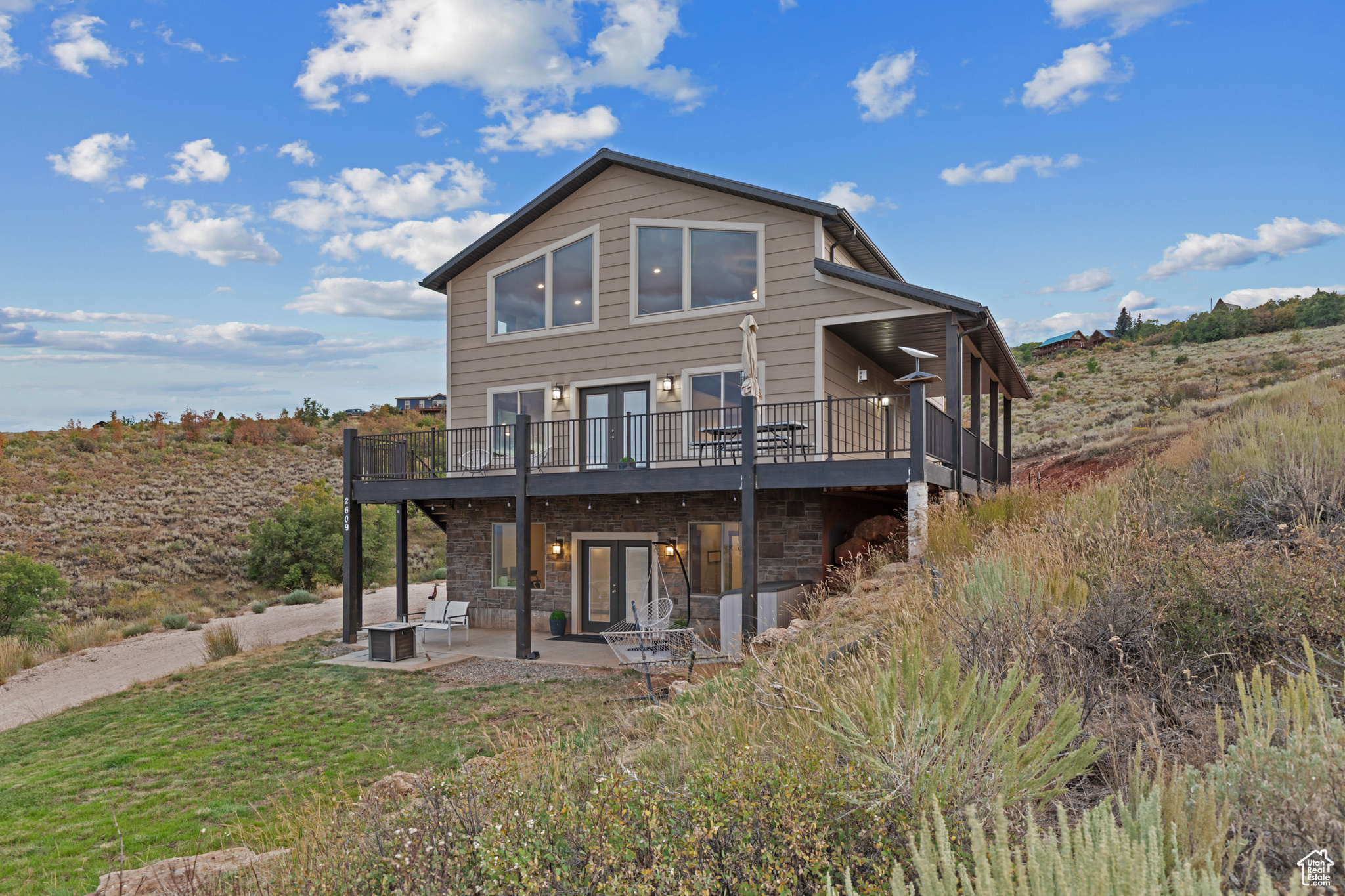 Stunning Bear Lake Views Spacious 4-Bedroom Cabin in Sweetwater Subdivision!! Enjoy panoramic Bear Lake views from this beautifully designed 4-bedroom, 3.5-bath cabin nestled in the desirable Sweetwater Subdivision. This spacious retreat features an open floor plan with a vaulted great room, rustic accent wall, impressive rock fireplace, and expansive windows that capture the stunning scenery. The kitchen is built for gathering, complete with a large island, stainless steel appliances, and an oversized dining area. The main-floor master suite offers a peaceful escape, featuring a double-sink vanity, a separate shower, and a luxurious soaking tub. Upstairs, a cozy loft overlooks the great room, along with two additional bedrooms and a full bath. The lower level offers a third family room, a fourth bedroom, another full bath, and a built-in garage-plenty of room for guests or extended family. With family rooms on all three levels, there's ample space for everyone to relax and enjoy. Step outside to the deck or patio for outdoor living and take in those unforgettable lake views. Sold fully furnished for a turnkey experience. Year-round access makes this cabin perfect for every season. Optional access to Ideal Beach Resort amenities includes heated pools, hot tubs, mini golf, sports courts, a playground, and a beautiful sandy beach. No short term rentals allowed in this HOA.