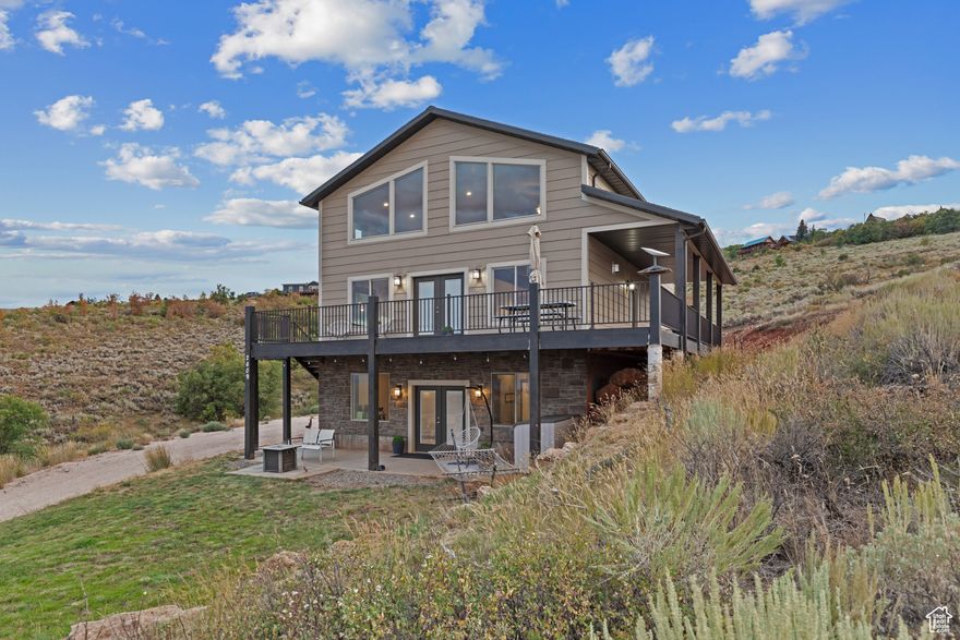 Stunning Bear Lake Views  Spacious 4-Bedroom Cabin in Sweetwater Subdivision!! Enjoy panoramic Bear Lake views from this beautifully designed 4-bedroom, 3.5-bath cabin nestled in the desirable Sweetwater Subdivision. This spacious retreat features an open floor plan with a vaulted great room, rustic accent wall, impressive rock fireplace, and expansive windows that capture the stunning scenery. The kitchen is built for gathering, complete with a large island, stainless steel appliances, and an oversized dining area. The main-floor master suite offers a peaceful escape, featuring a double-sink vanity, a separate shower, and a luxurious soaking tub. Upstairs, a cozy loft overlooks the great room, along with two additional bedrooms and a full bath. The lower level offers a third family room, a fourth bedroom, another full bath, and a built-in garage-plenty of room for guests or extended family. With family rooms on all three levels, there's ample space for everyone to relax and enjoy. Step outside to the deck or patio for outdoor living and take in those unforgettable lake views. Sold fully furnished for a turnkey experience. Year-round access makes this cabin perfect for every season. Optional access to Ideal Beach Resort amenities includes heated pools, hot tubs, mini golf, sports courts, a playground, and a beautiful sandy beach. No short term rentals allowed in this HOA.