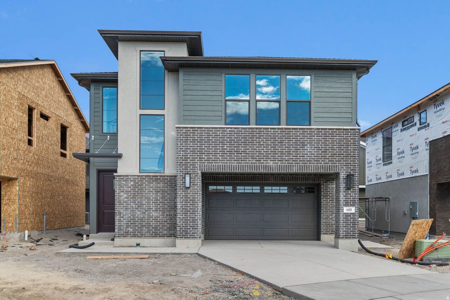Beautiful brand new Keystone Ballpark cottage home in a great Lindon community near shopping and highway access! This modern home features a stylish kitchen with gray maple cabinets, quartz counters, tile backsplash and stainless steel gas appliances. Durable flooring includes laminate hardwood flooring, carpet and vinyl tile. Other interior features highlight can lighting, energy efficient options, metal railing at the stairs and craftsman base & casing. The owner's bathroom offers a retreat with quartz shoer surrounds and black matte hardware. Comes fully landscaped that is maintained by the HOA for easy care living!