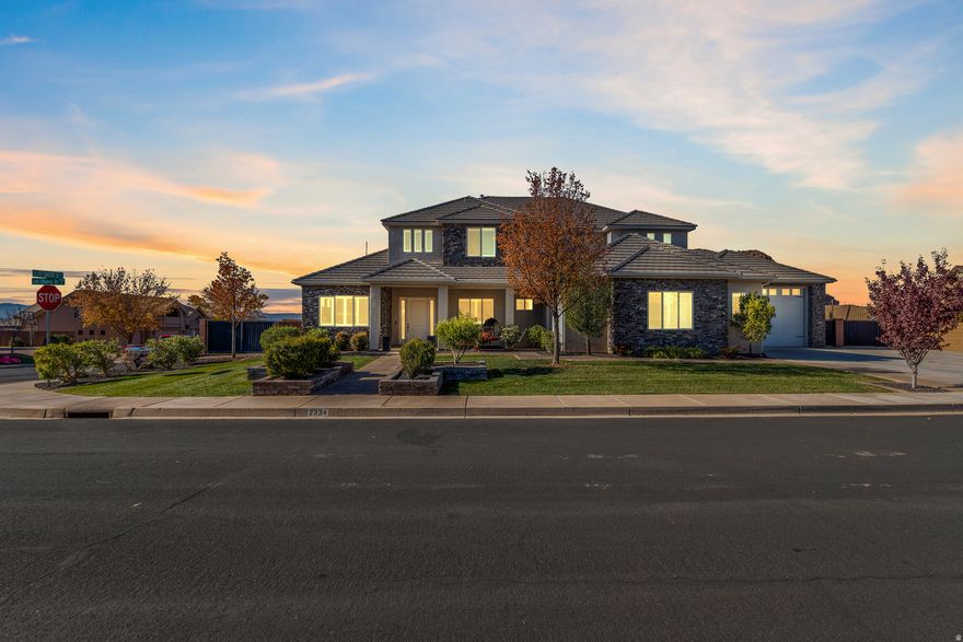 Discover this exceptional Washington Fields home set on a generous .38-acre corner lot, offering privacy, beautiful views, and ample space for a future pool. The stunning kitchen offers double ovens, a drop-in cooktop, Scotsman pebble ice maker, reverse osmosis, oversized fridge/freezer, a large hidden butler's pantry, decorative hood, huge island, and a window overlooking the backyard. The great room includes a gas fireplace, floating shelves, custom built-ins, and abundant natural light. Enjoy a spacious main-level laundry room with a sink plus secondary hookups upstairs, a stylish mud bench, and generous storage throughout. The thoughtful layout includes a Jack-and-Jill bathroom with quartz counters and double vanities, tiled shower surrounds, and a luxurious primary suite with a coffered ceiling, private patio, and views of the mountains and Red Cliffs Temple. The primary bath features a soaker tub, steam shower with rain head, and a walk-in closet with built-in drawers. Automated blinds enhance comfort and convenience. The oversized 4-car garage includes a mini-split HVAC system, and the home provides an unfinished basement with 10 ft. ceilings, separate garage entrance, and excellent potential to finish for added living space or rental income.