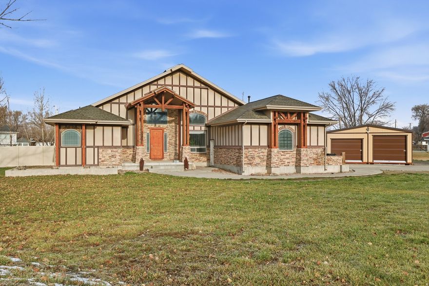 Single-level living at its absolute best in the peaceful country town of Corinne, Utah! This incredible property sits on .62 acres and is packed with upgrades both inside and out, offering the perfect blend of space, functionality, and comfort. The backyard is a dream, featuring a 20x24 shop plus a 10x24 insulated workshop with a mini-split system and 220 power-perfect for hobbies, projects, or extra storage. A newer vinyl fence installed in 2022 adds privacy and gives the property a beautifully finished look. Step inside and be wowed by the soaring 24-foot vaulted ceilings, 4 spacious bedrooms, and 3 bathrooms. You'll love the granite countertops throughout, stylish LVP flooring, cozy pellet stove fireplace, and the newer AC unit installed in 2022 for year-round comfort. The open, bright layout is ideal for entertaining and everyday living alike. All appliances are included-even the washer and dryer-making this home truly move-in ready. The attached 2-car garage also offers 220 power, and the garage lift is negotiable for those who want the ultimate workspace setup. This home checks every box and more-properties like this are rare and won't last long. Come see it before it's gone! Home being sold as is and price has been adjusted for necessary cosmetic upgrades . Don't forget to click the tour link in the listing to view the video tour and the 3D Matterport tour!