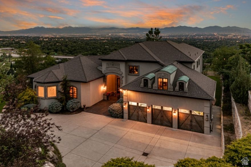 Where timeless elegance meets modern luxury-experience panoramic views and world-class living in the heart of Holladay Spectacular modernized European style home where you will find exquisite finishes throughout. This stunning home is perched on the east bench of Holladay with over 9,800 square feet spread over three floors and sits on 1.05 acres. Quite possibly offers the most breathtaking views of the Salt Lake Valley. The elegant architecture, large windows, and grandeur two-story volume ceilings will blow you away as soon as you enter this luxurious home. The main floor comprises of a stunning grand entry, a formal living room, a formal dining area, a great room, two breathtaking fireplaces, an office finished in custom woodwork, a master suite, kitchen, laundry and two half baths. The kitchen is a unique work of art with an unprecedented level of quality and attention to detail, custom cabinets, granite countertops, and a luxurious wood bar. The kitchen is fully equipped with a 48'' 8 burner gas range, double ovens, vented steel hood, and pot filler to prepare the finest gourmet meals. The lavish main floor master suite offers silver leaf ceilings, sitting area and stunning views of the valley exclusive massive his and her walk-in closets a sumptuous bathroom consists of garden tub, walk-in shower, dual vanities, private toilet rooms. Upstairs consists of a secondary family room perfect for entertaining, custom iron railings, bedroom full bath and bonus room and wet bar above the garage. Additional amenities include a downstairs mother in-law kitchen, two bedrooms, with en suite bathrooms, great room, walkout to the backyard patio. Click on the virtual tour for the high-quality images of this masterpiece. Agent related to seller, square footage figures are provided as a courtesy estimate only and were obtained from the county.