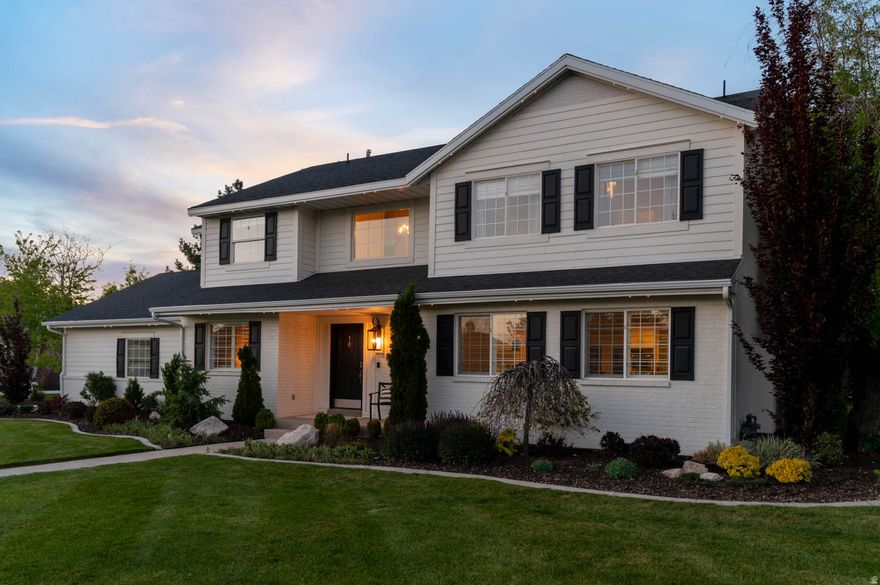 Set on nearly a half-acre of private, tree-lined ground in Highland, this two-story home delivers the rare combination of mature landscaping, meaningful updates, and outdoor living that actually gets used. The grounds are surrounded by ultra-mature trees that create a tucked-away feel you cannot manufacture or wait around for. Out back, a covered pergola anchors a paver patio with a built-in fire pit, sitting area, and overhead fan, all positioned to take in the yard and the mountains beyond. A detached studio with power, heating and cooling sits just off the patio and works as a true office, gym, or creative space without ever stepping into the main house. Inside, the kitchen has been opened up with white shaker cabinetry, quartz counters, a granite island, gas cooktop with stainless hood, glass-front uppers, and a tile backsplash that ties the space together. The primary suite is the headline. Oversized bedroom, a spa-level bathroom with a glass-enclosed dual-head shower with body sprays and a freestanding soaking tub, and a walk-in closet large enough to hold a center island dresser with stacked laundry built directly into the closet. A large bonus room gives the kids their own zone, and an additional flex room functions as a gym or a fifth bedroom depending on what the next owner needs. The systems and improvements list is where this home separates itself. The home has been fully repiped in 2026 with fresh interior paint, AC and furnace replaced in 2021, tankless water heater in 2021, new water softener in 2026, gutters in 2024, and a newer driveway. The detached shed and studio were built in 2024 with finished interior, lighting, and climate control. Outside, sprinklers and full landscape were redone in 2021, the pergola and pergola lighting went in in 2020, and architectural exterior lighting wraps the home. The garage is a two-car footprint but built oversized with finished flooring and custom shelving, an important detail for buyers who need real storage in a two-car configuration. Location is the closer. Sitting just off the SR-92 corridor with quick access to I-15, Silicon Slopes, Lone Peak High, and the mouths of American Fork and Provo Canyons, this property gives you a half-acre, mature-tree lifestyle in one of Utah County's most established neighborhoods without sacrificing commute or convenience. Homes with this combination of lot, updates, and outdoor living do not surface often in Highland.