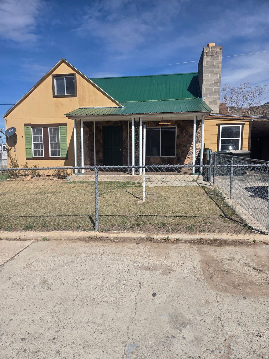 Large Family rental. Could be 3 bedrooms. fenced yard, carport with a storage area. Call agent for showing.