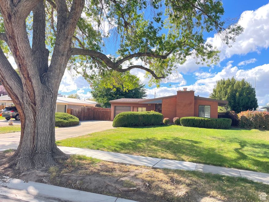 Charming Rambler with Amazing Garage!  Large detached Garage with heat and ac!  Home has large windows, hardwood floors, Plantation Shutters, and is clean and neat!  Large Lot with auto sprinklers, fully fenced and in an amazing neighborhood.