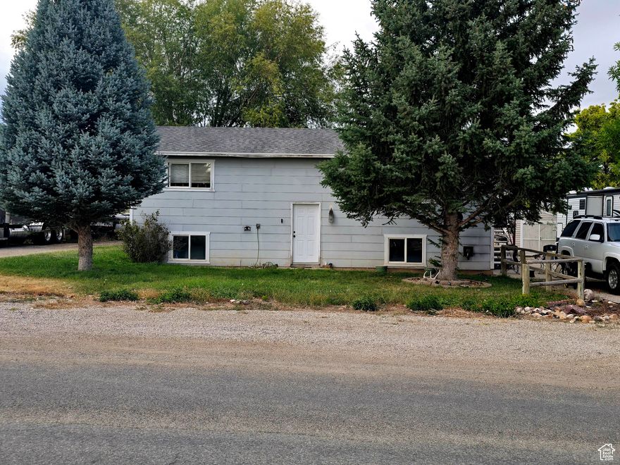 Shop, home and a large country lot. Beautiful views 4 bedroom 2 bath home outside of town. Great area with mature trees and RV hook ups.