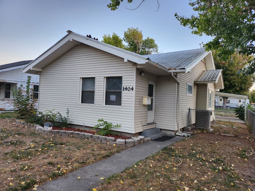 Renovated 1920s home blending vintage character with modern updates. Enjoy new interior and exterior paint, new carpet, and Luxury Vinyl Plank (LVP) flooring. The kitchen has a new stove/oven and dishwasher. The property is on a corner lot with a fenced yard, automatic sprinklers, a 1-car detached garage, and a storage shed. The home features a durable metal roof and an unfinished basement. Located on numbered streets in a central city location.