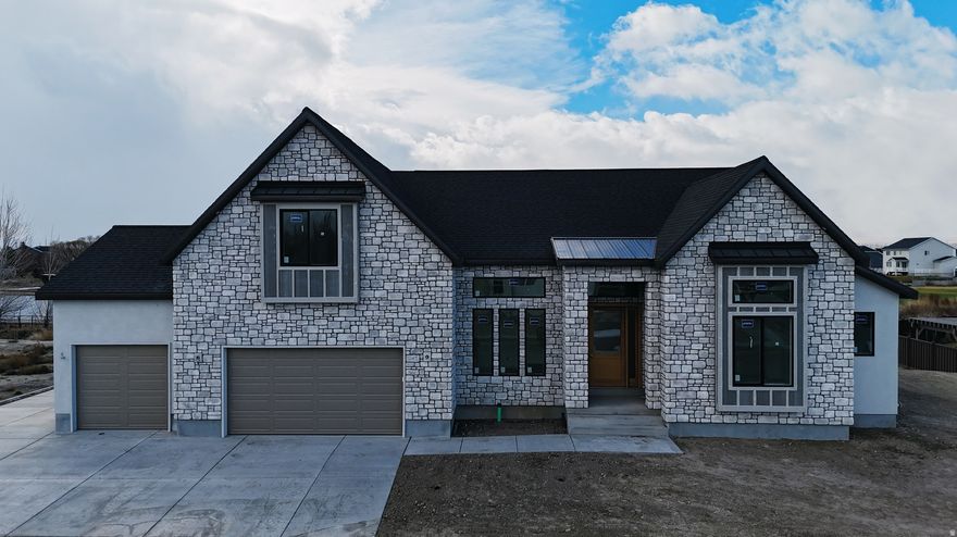 The Roosevelt Floor Plan  Executive Living in our South Creek Lehi Neighborhood. This executive-style floor plan designed to appeal to families of all ages - from young professionals to established households looking for lasting comfort and versatility. This thoughtfully designed home features a basement entrance ready for a future ADU, offering excellent potential for additional living space, guest quarters, or rental income. This home includes a spacious 10' x 18' deck perfect for outdoor entertaining. Inside, you'll find designer finishes throughout, combining luxury, function, and timeless style. Construction is well underway, with completion first part of March - don't miss your chance to make to live here we are almost built out! 20 K Preferred lender incentive