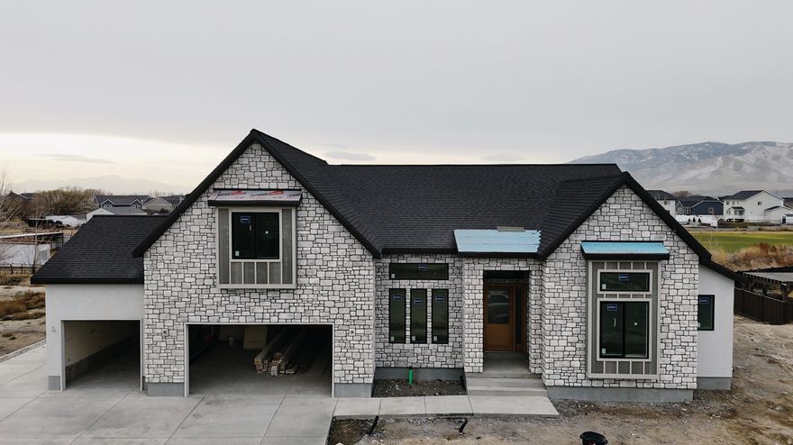 The Roosevelt Floor Plan  Executive Living in our South Creek Lehi Neighborhood. This executive-style floor plan designed to appeal to families of all ages - from young professionals to established households looking for lasting comfort and versatility. This thoughtfully designed home features a basement entrance ready for a future ADU, offering excellent potential for additional living space, guest quarters, or rental income. This home includes a spacious 10' x 18' deck perfect for outdoor entertaining. Inside, you'll find designer finishes throughout, combining luxury, function, and timeless style. Construction is well underway, with completion first part of March - don't miss your chance to make to live here we are almost built out! 20 K Preferred lender incentive