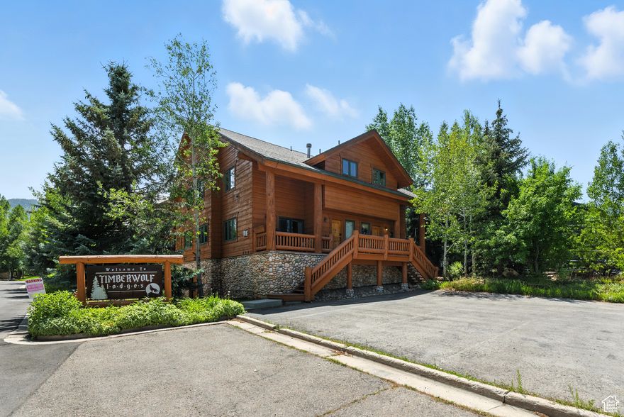 Nestled in the charming enclave of Timber Wolf Lodges, this beautifully maintained end-unit townhome offers the perfect balance of mountain serenity and convenient access to world-class recreation. Originally built for skiers during the last Winter Olympics in Utah, this retreat is just minutes from Canyons Village and provides effortless access to skiing, snowboarding, hiking, golf, and breathtaking mountain views. The nearby bus and trail systems make exploring Old Town and Kimball Junction a breeze, where you'll find five-star dining, boutique shopping, art galleries, and vibrant nightlife. Inside, this 1,054 sq. ft. mountain getaway exudes rustic charm with timber beams, wood-slat ceilings, slate and hardwood floors, and a cozy river rock gas fireplace. The thoughtfully designed layout features two spacious master suites with vaulted ceilings, jetted tubs, and en-suite baths, while the main level offers a fully equipped kitchen, airy living room, laundry area, and additional half-bath. Step outside onto your private deck and unwind in the hot tub, surrounded by mature trees for added privacy. With the Sofa Bed in the family room area, it allows this property to sleep 6! Additional features include an underground parking space, guest parking, and a private storage closet for added convenience. Offered fully furnished and move-in ready, this home is perfect as a private mountain retreat or a profitable income property. Don't miss this opportunity-schedule your tour today and experience the best of Park City living! Square footage figures are provided as a courtesy estimate only and were obtained from previous listing. Buyer is advised to obtain an independent measurement. Unbranded Video: https://www.youtube.com/shorts/hZs0LEC4PVE