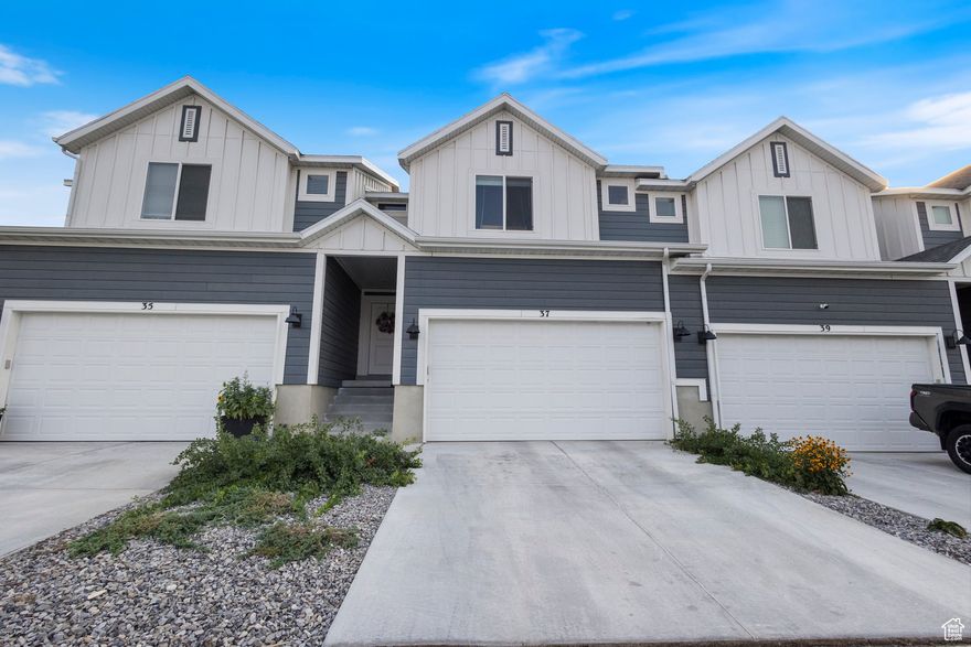 This mid unit townhome is located in the Sun Sage Meadows community in Grantsville. This thoughtfully designed home features very spacious bedrooms with generous closets. It includes 3 Bedrooms, 2.5 bath, and 2-Car Garage, fully fenced backyard, and unfinished basement for extra storage. Relax on your patio approx. 9' deep x 24' wide for family BBQs! Open concept living on the main floor. The most sought-after upgrades are included in this listed home, such as white cabinets, stainless steel appliances with a gas range, dishwasher, and microwave, white quartz countertops in the kitchen and in the upstairs bathrooms! We've included laminate wood floor in the kitchen, dining, entry, and extended through the family area. Square footage figures are provided as a courtesy estimate only. Buyer is advised to obtain an independent measurement.