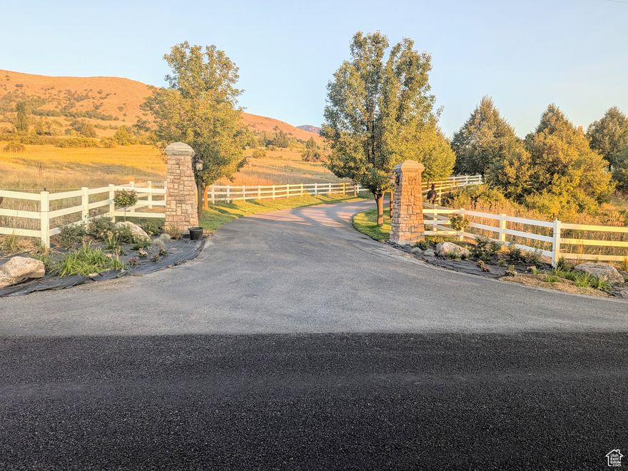 Incredible opportunity to own one of the finest view lots in North Cache county. The private paved lane entering the subdivision is lined with trees, white vinyl fencing and charming "London look" street lamps. If you like this entry during the daylight you will love it at night as you take in the lights of Cache County. Peaceful privacy abounds with only 5 large large lots in this subdivision. Most of the 9.15 acre sire is fenced with white vinyl fencing. There are multiple places to tap into fresh spring water and the septic system is in and stubbed to the lot. Electricity is ready to go also. 360 degree views, fencing, mountain access, privacy, and all utilities in place. Opportunities like this seldom come available. This is a lot/location where dreams can come true. Don't miss it! You should at least take a look.