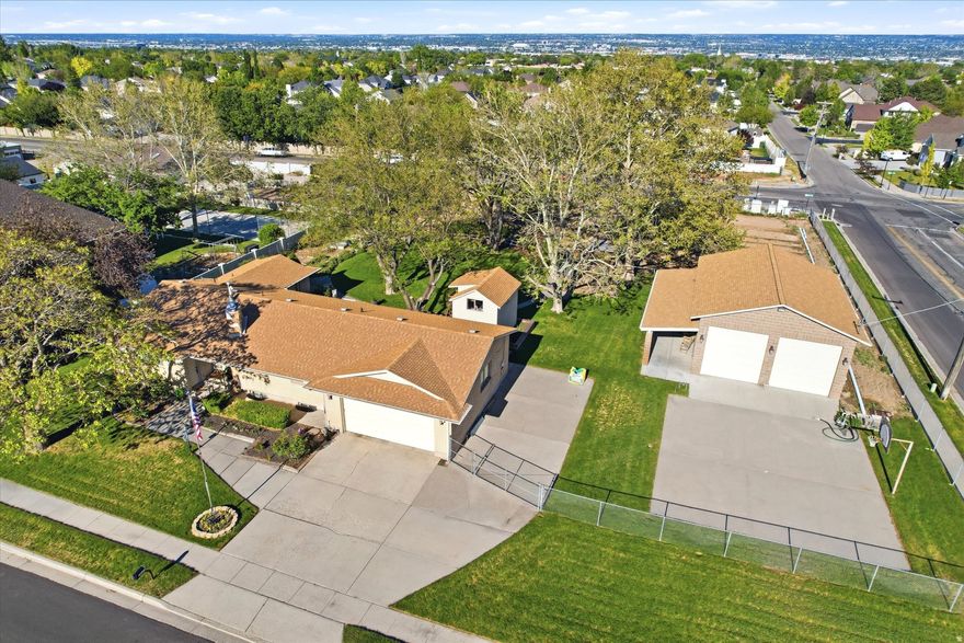 Nestled in the heart of South Jordan, this rare 1.02-acre property offers the perfect blend of luxury living, functionality, and future investment potential. This stunning Rambler-style home features 6 spacious bedrooms and 4 beautifully appointed bathrooms with a thoughtfully designed layout ideal for both everyday living and entertaining. The fully finished basement includes a separate ADU, creating incredible flexibility for multi-generational living, rental income, or private guest accommodations. Outside, the property truly shines with a detached oversized RV garage offering abundant space for recreational vehicles, toys, storage, or a workshop setup. Enjoy your own private homestead with mature fruit trees, flourishing vegetable gardens, and lush landscaping that creates a peaceful retreat right in the city. The expansive lot provides room to roam while still being conveniently located near shopping, dining, schools, and freeway access. Adding even more value, the property offers subdivision potential, giving buyers a unique opportunity to maximize their investment now or in the future. Properties with this combination of acreage, amenities, income potential, and development opportunity are exceptionally rare in South Jordan.  **Property can be subdivided per South Jordan City!