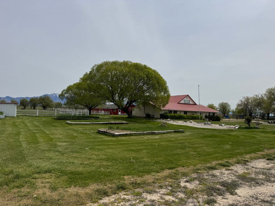 Welcome to the dream life... This is a rare opportunity to own a Weber County homestead with 3.01 acres of land (two parcel numbers) a 3,536 sq ft home, huge barn/garage with horse stalls, garden, beautiful yard, your own pond, and - the cherry on top - a hot tub to relax in after a day on your farm. Home features 6 big bedrooms, 2 huge living rooms, 2 bathrooms, roomy kitchen, formal dining, sunroom, wood stove, and so much storage, you'll never run out of space. (See the virtual videos) Paid off solar panels. Outside you'll have plenty of open space, corrals, pastures and pens for all the animals you could ever want to raise. A sprinkling system keeps the lawn and garden green and one owned water share is included. Numerous outbuildings include a huge barn with space for cars, trucks, tractors and toys, and 5 horse stalls with concrete floors and custom sliding doors.   Acreage, parcel configuration, and property details are provided as a courtesy estimate only. Buyer and buyer's agent to verify all information.