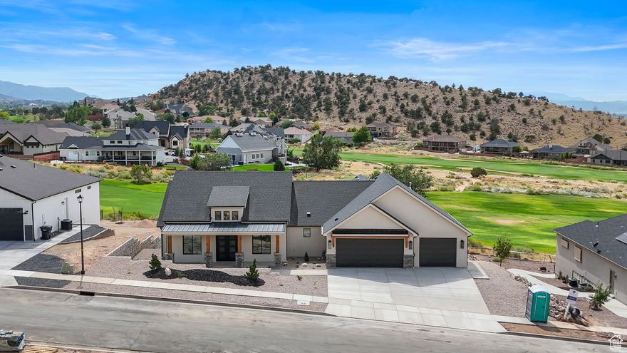 Luxury golf course retreat, blending elegance with everyday comfort. Bright, open living spaces showcase soaring ceilings, expansive windows, and panoramic views. The main kitchen features custom cabinetry, and a spacious island, enhanced by hardwood floors and an integrated sound system. The lower level offers a second kitchen, large living area, and versatile flex room, perfect for a gym, office, or studio. Outdoor living excels with a covered porch, upper deck, and an outdoor kitchen with fireplace, ideal for year-round entertaining. Additional highlights include iron doors with built-in screens and the convenience of an HOA that provides snow removal. A rare opportunity to own a golf course property with some of the best views in town. Immerse yourself in this luxurious lifestyle.