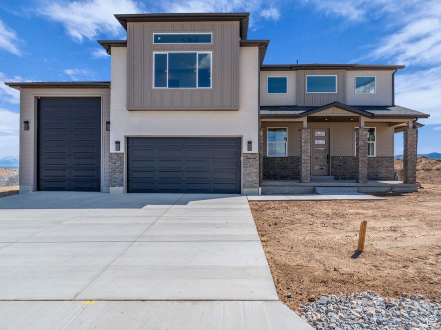 Beautiful brand new home with panoramic views of Cedar Valley and Pole Canyon. No HOA. Seller will pay up to $18,000 towards Buyers rate buy down or other closing costs. This home nestled on a spacious 1-acre lot. Designed for both comfort and functionality, this property features a 40'+ RV garage with oversized doors on both the front and back of the home perfect for toys, tools, and trailers. The owner's suite offers a true retreat with dual walk-in closets and ample space for relaxation. The unfinished basement is already rough-plumbed for a full apartment, giving you the flexibility to expand or create income potential.