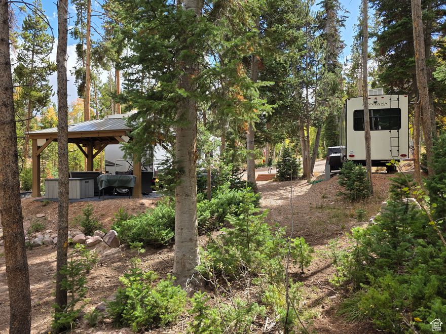 You're going to love this lot!  Remember when you could run up to the Uintas, tuck your trailer into a nice secluded spot, snuggle into the pine trees and escape the crowds?  You can have that again with this property.  Located in a quiet corner of the Manor Lands gated community, this 5 acre lot gives all the secluded camping feels, with the added comforts of  power and propane, septic, garage to park your toys, and 5,000 gallons of water storage that pump directly to 3 RV pads.  Extra RV parking is available without septic and water amenities. This spot was designed to live the Uintas dream: a quiet, woodsy camp that's always available, always set-up, with a cozy firepit and gazebo for outdoor enjoyment and maximum trailer comfort.  It's not to late to enjoy the crisp fall weather, snatch this one up soon!