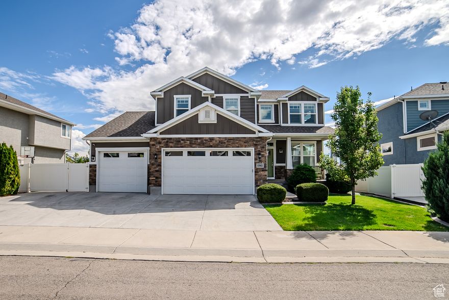 Beautiful home in a fantastic location with a truly one-of-a-kind garage! This oversized 4-car garage features a 19' x 21' two-car bay and an 11' x 39' third-car bay-plus rare 14' x 39' RV parking. The professionally landscaped yard frames unobstructed Wasatch Front mountain views -and with no backyard neighbors, you'll enjoy privacy and serenity every day. A welcoming covered front porch sets the stage for relaxing evenings, while the fully finished basement offers 9-foot ceilings and convenient cold storage. Exterior can lights highlight this home's curb appeal both day and night. Located just minutes from The District's shopping, dining, and entertainment, this home has been cared for inside and out.