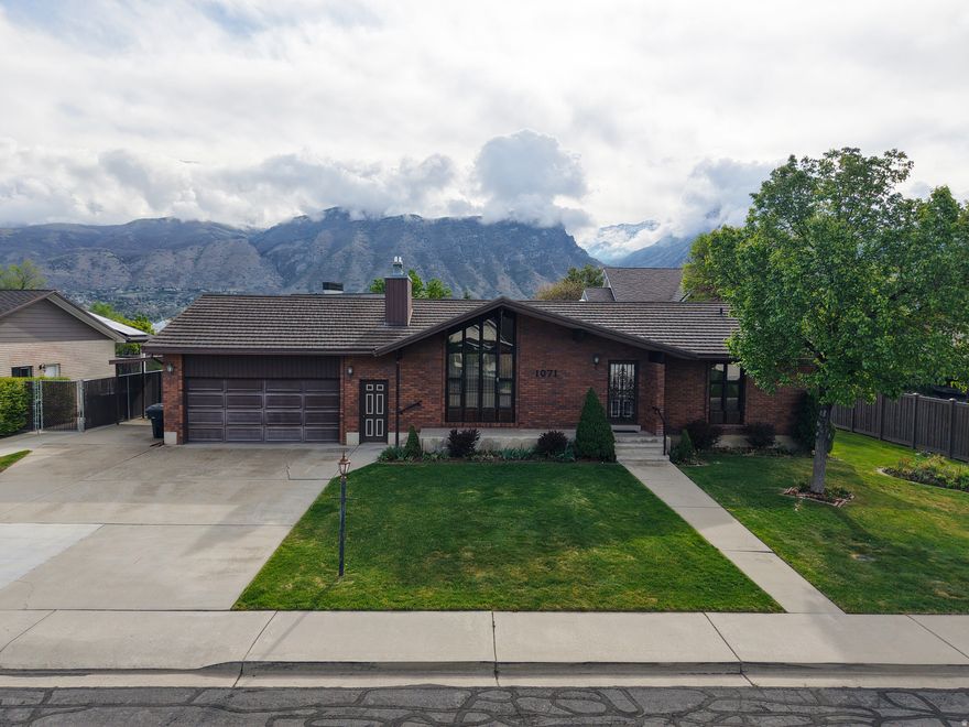 Well-maintained home nestled in a prime location near BYU and UVU, with dining and shopping conveniently close by. The property offers a fully fenced yard with RV parking and a back cement patio, providing great space to enjoy the outdoors. The home has been owned by the same owner since it was built in 1978 and features a lifetime aluminum roof. Solar panels, fully paid for, were installed in January 2017. Located in a highly sought-after area, the home offers a sense of seclusion while still providing quick access to everything Orem City has to offer. Inside, the large basement family room includes a gas fireplace. Upstairs, the living room features a beautiful custom-built rock hearth and a working gas fireplace. The master bedroom includes a vanity area just outside the ensuite bathroom, offering additional space. The sprinkler system and lawn have been well cared for. A sunroom added in 1993 provides a covered space to relax while staying out of the weather, allowing enjoyment of the space year-round.  Unfinished laundry room and storage area in the basement.  Lots of storage space!  Square footage figures are provided as a courtesy estimate only and were obtained from county records. Buyer is advised to obtain an independent measurement.