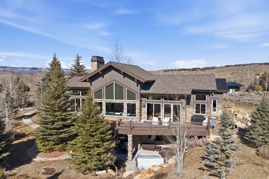 Beautiful Promontory Home With Sweeping Ski Resort Views! Experience refined mountain living in this beautiful Mountain Contemporary positioned in Promontory's Homesteads neighborhood.  Ideally situated between the Equestrian Gate and the Village Center, this home offers effortless access to the community's world class amenities while maintaining a serene sense of privacy. Sweeping, unobstructed vistas of the Wasatch Back ski resorts define the home's setting, creating a dramatic backdrop from the moment you step through the front door. The warm, open floor plan welcomes you into an expansive great room anchored by a beautifully appointed chef's kitchen and generous walk in pantry. Floor to ceiling glass opens to an oversized deck, delivering seamless indoor outdoor living ideal for elegant entertaining or relaxed gatherings. The lower level extends the home's livability with a spacious family room, wet bar, and two private guest suites-each thoughtfully positioned for comfort and privacy-with direct access to a covered patio and hot tub. This single owner residence has been meticulously maintained and recently refreshed with quartz countertops, new interior and exterior paint and stain, updated lighting, new wood, tile, and carpet flooring, and upgraded HVAC systems. Every detail reflects care, quality, and timeless style. Beautifully furnished and exceptionally well appointed, this 3 bedroom, 5 bath retreat- complete with a 3-car heated garage-offers an extraordinary opportunity to enjoy the full Promontory Club lifestyle and the year round beauty of Park City's four season mountain environment.